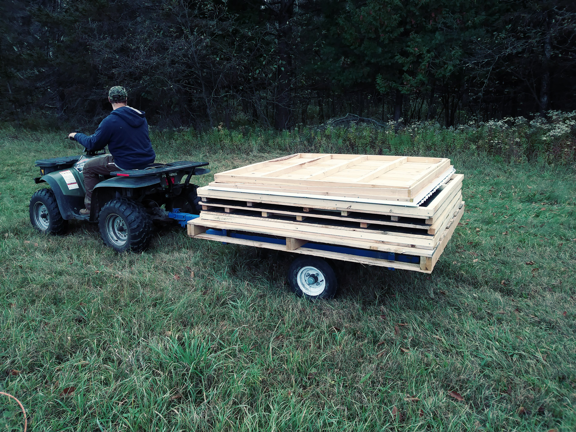 Four-wheeler hauling wood for deer blind construction
